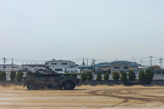 Armored vehicle driving on dusty ground